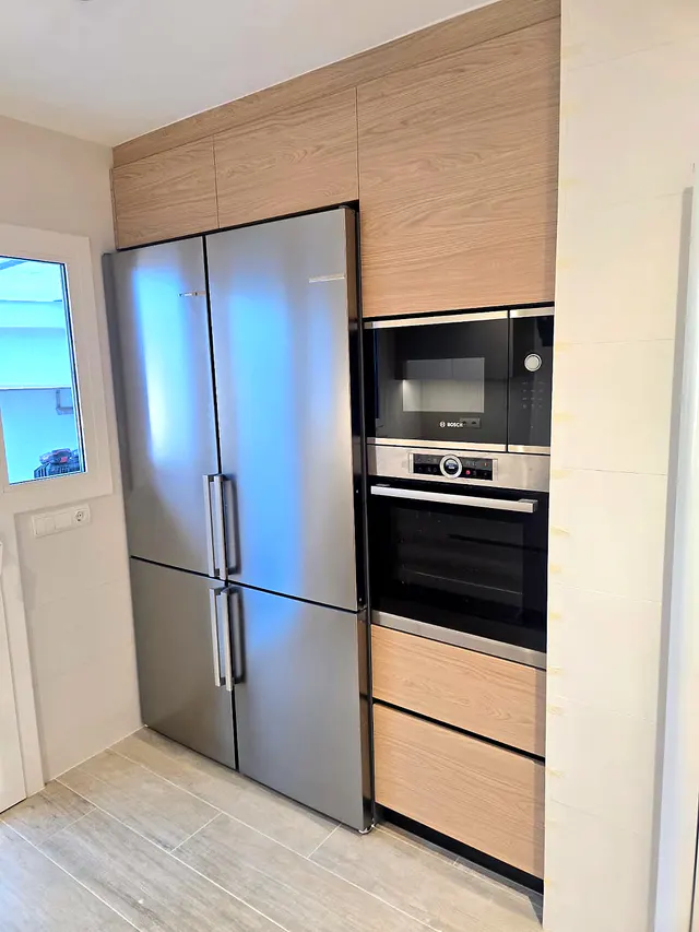 Columna en acabado madera con frigorífico de dos puertas, horno y microondas integrados
